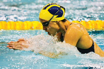 Dr. Silva Merea competing in a breaststroke event for the University of Michigan.