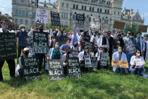 University of Connecticut otolaryngology residents David Wilson, MD, and Roshansa Singh, MD, (standing second and third, from right, respectively) and Lawrence Kashat (seated row, second from right) participating in the White Coats for Black Lives movement during the June 6, 2020, BLM March in Hartford, Conn.