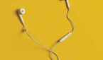 Earbuds against a yellow background